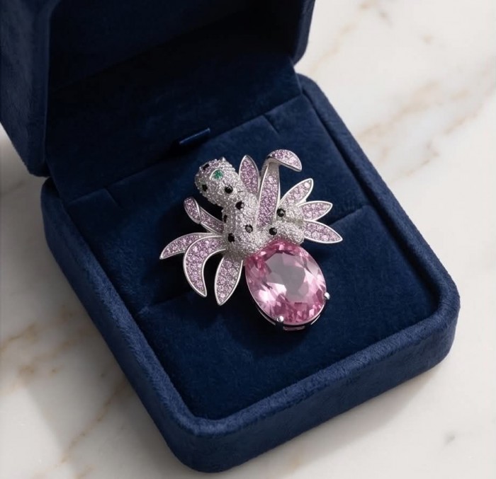 Pink Cheetah authentic 12.5 carat Swiss Blue Topaz .925 Sterling Silver Handcrafted pendant brooch - Jewelry piece with pink topaz in an open blue velvet box, top view.