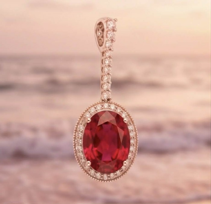 Giovanna Natural 20.8 carat Red Topaz .925 Sterling Silver handcrafted Statement pendant - Close-up of Giovanna Red Topaz pendant against a blurred sunset background