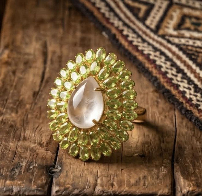 Francesca - Brazilian Rose Quartz Peridot 28.5 carat 18K Gold over .925 Sterling Silver handcrafted Large Ring size 7 - Close-up of Francesca ring with rose quartz and peridot stones on wood.