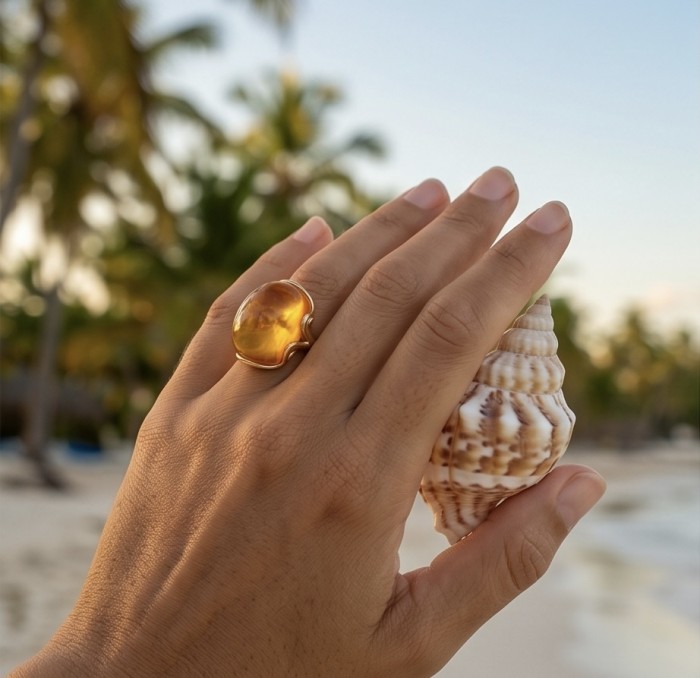 Authentic Golden Butterscotch Baltic Amber 14K Gold over .925 Sterling Silver entirely handcrafted LARGE ring; s. 7 adjustable - Amber ring worn on hand holding seashell, beach background