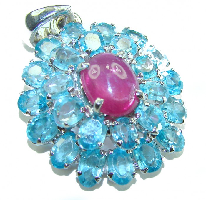 Magnificent Jewel 18.5 carat Ruby Swiss Blue Topaz .925 Sterling Silver handcrafted incredible Statement Pendant - Close-up of jewel with ruby center and blue topaz gems in silver setting.