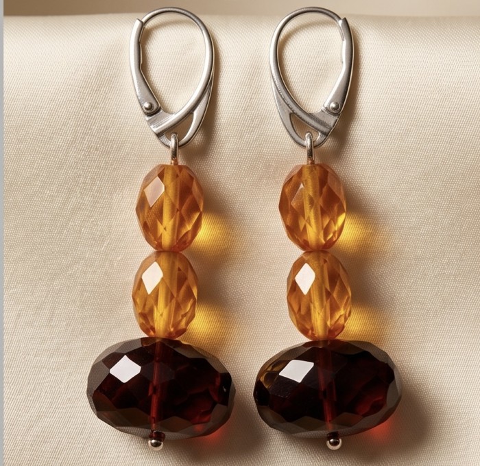Luminous fossilized Beauty natural Baltic Amber .925 Sterling Silver entirely handcrafted earrings - Amber earrings with sterling silver hooks, front view on fabric.