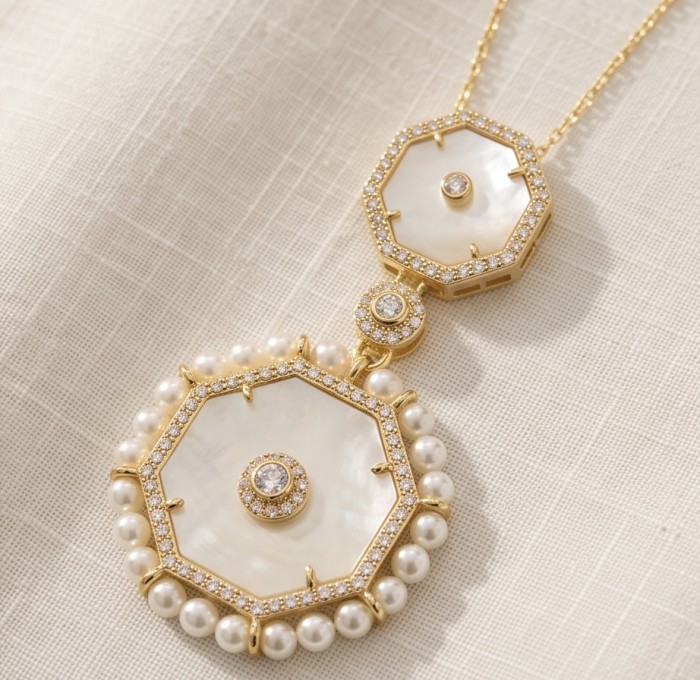 Precious natural creamy Blister Pearl 14K Gold over .925 Sterling Silver Necklace - Close-up of a pearl and gold pendant on a textured fabric background.