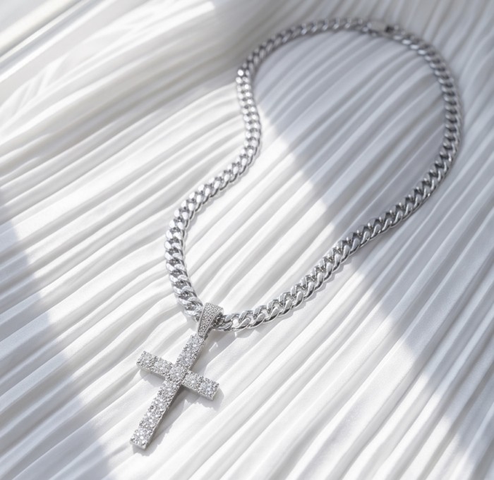 Precious White Cross Genuine 14K White Gold over .925 Sterling Silver handmade necklace - Silver cross necklace on pleated white fabric, top view.