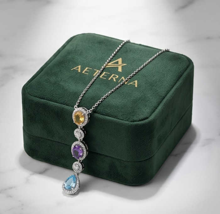 Infinity 8.5 carat Authentic Multigems Rhodium over .925 Sterling Silver handcrafted Statement necklace - Infinity multigem necklace on green velvet box, top view.