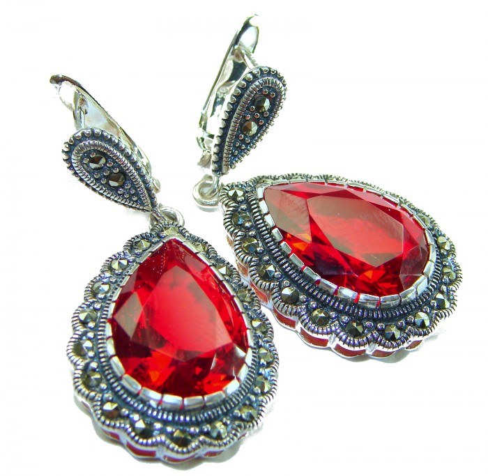 Crimson Fire Authentic 18.9 carat Garnet .925 Sterling Silver brilliantly handcrafted earrings - Close-up of Crimson Fire garnet earrings with sterling silver detail.