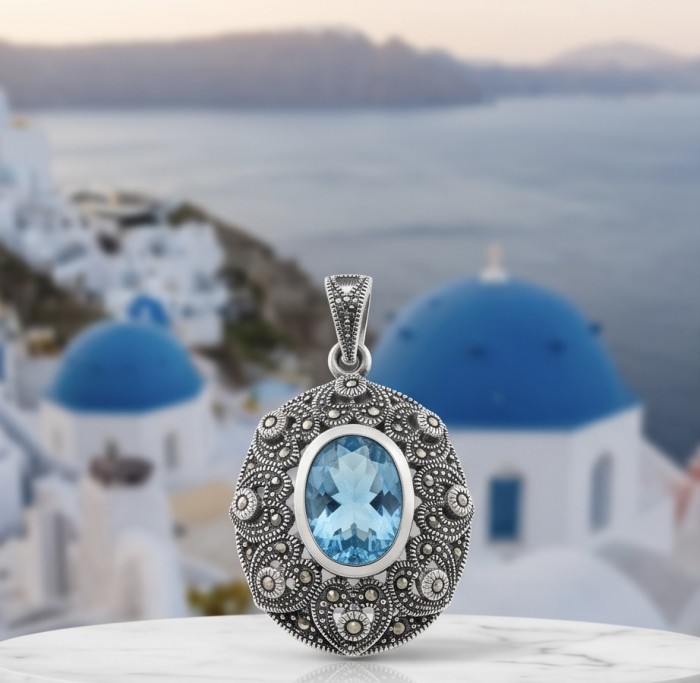 Vintage style 10.8 carat Swiss Blue Topaz .925 Sterling Silver DIPPED IN RHODIUM handmade Pendant - Close-up of vintage Swiss Blue Topaz pendant against scenic background.