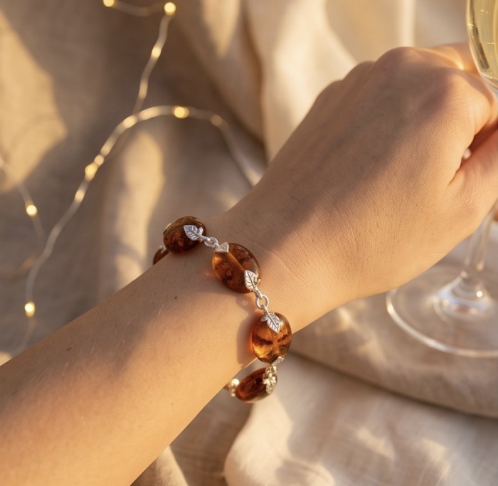 Golden Baltic Amber .925 Sterling Silver dipped in rhodium handamde Bracelet - Amber bracelet worn on hand, close-up view.