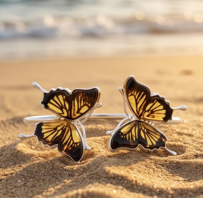 Golden Butterfly Genuine carved Baltic Amber .925 Sterling Silver dipped in rhodium handamde Bracelet - Golden butterfly amber bracelet on sand at beach close-up