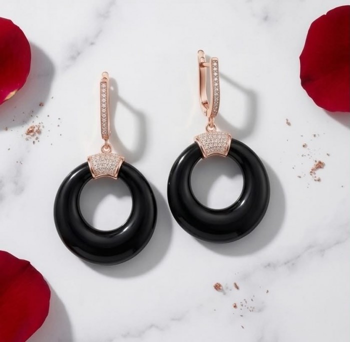 Outstanding authentic Onyx .925 Sterling Silver dipped in 18K Rose Gold Earrings - Black Onyx earrings with rose gold accents on marble, top view.