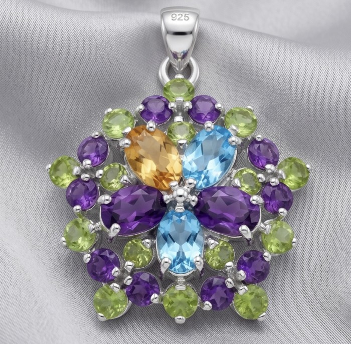 Colors of the Earth Precious 18.5 carat Multigem .925 Sterling Silver dipped in rhodium Pendant - Pendant close-up with multicolored gemstones on silver fabric background