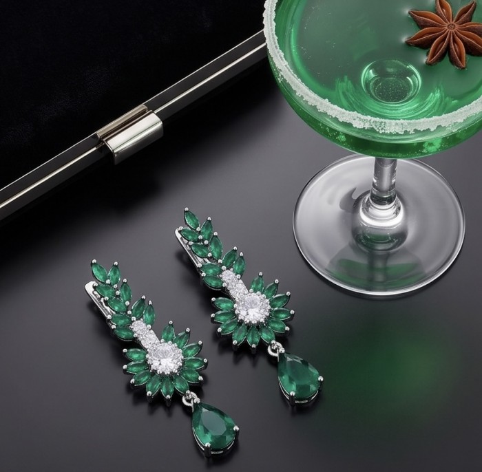 Giovanna - Authentic 7.9 carat COLOMBIAN EMERALD .925 Sterling Silver handcrafted earrings - Emerald earrings side view with green cocktail and clutch backdrop