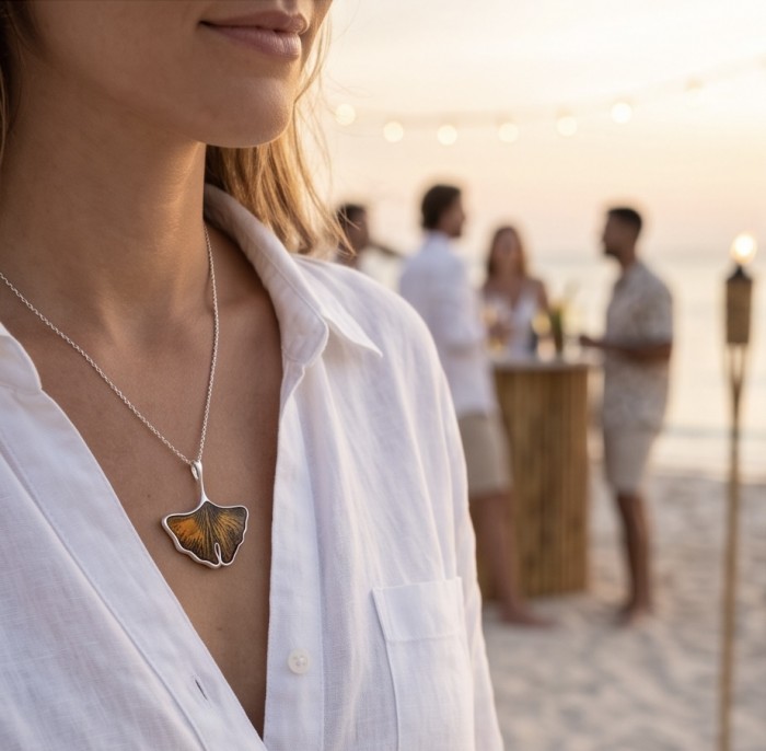 Calla Lily Prehistoric Authentic Butterscotch Baltic Amber .925 Sterling Silver beautifully handcrafted Pendant - Woman on beach wearing Calla Lily amber necklace side view