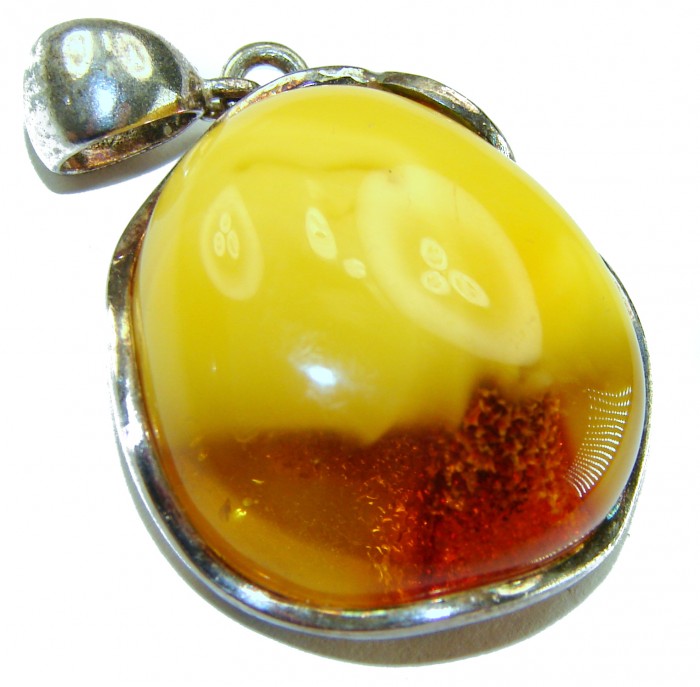 Sea Treasure Prehistoric Authentic Butterscotch Baltic Amber .925 Sterling Silver beautifully handcrafted Pendant - Close-up of butterscotch Baltic amber pendant with silver setting.