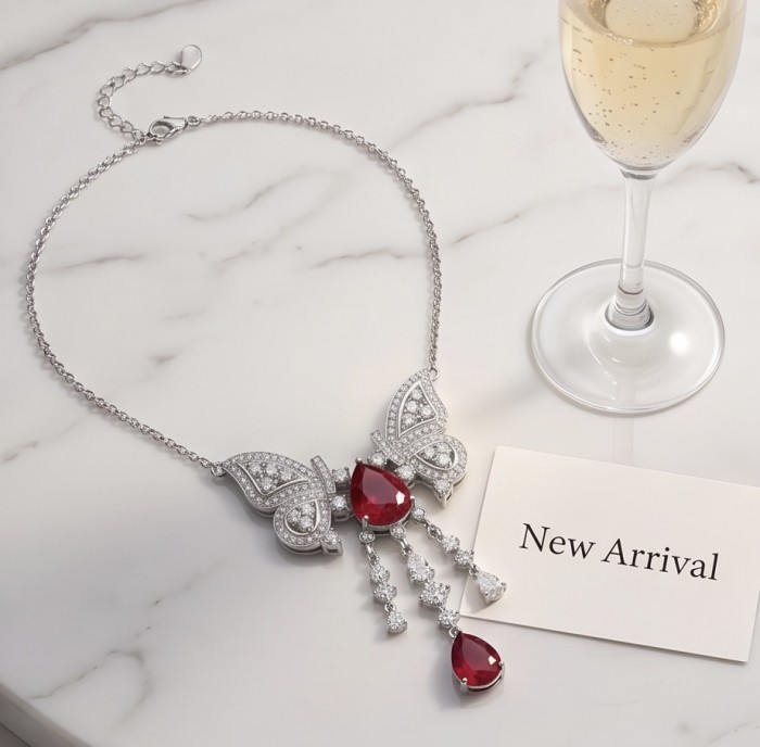 Giovanna - Magnificent Jewel 6.8 carat Ruby .925 Sterling Silver handcrafted incredible Statement Necklace - Butterfly ruby necklace on marble with champagne, top view