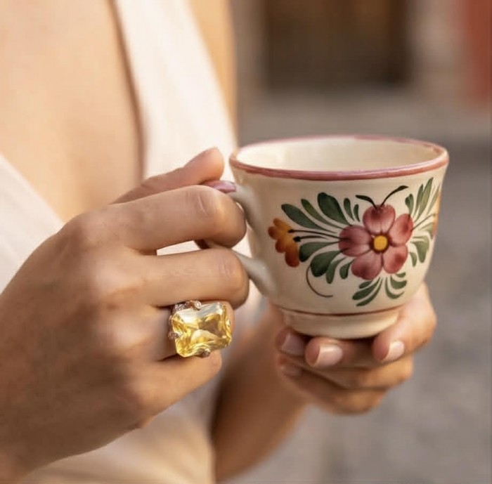 Solid 35.8 carat Genuine Yellow Sapphire 2 tones .925 Sterling Silver handcrafted ring size 7 adjustable - Yellow sapphire ring on hand holding floral cup, close-up view.