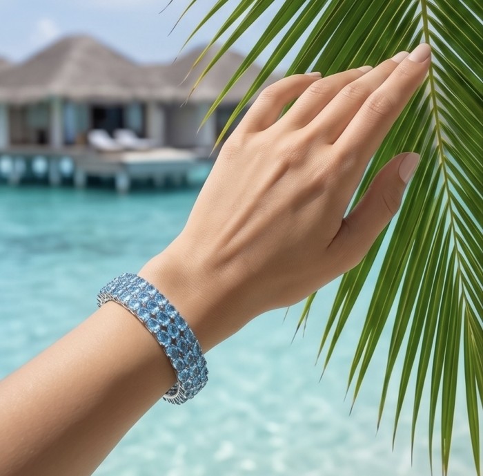 Serenity - Spectacular authentic 145.5 carat Swiss Blue Topaz .925 Sterling Silver handmade bangle Bracelet - Worn on hand, Swiss Blue Topaz bracelet by beach and palm leaves.