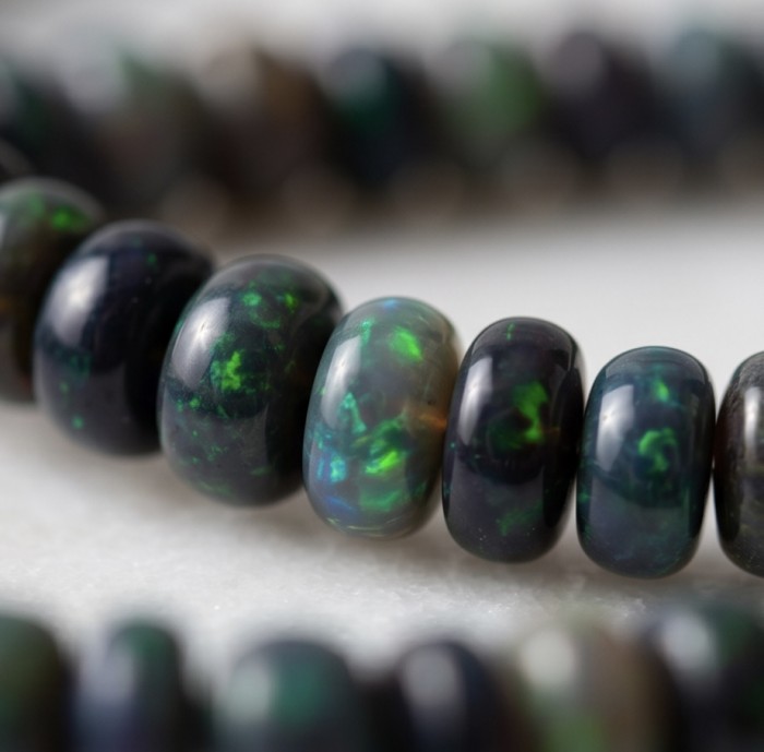 Mystery 22.2 carat Black Opal .925 Sterling Silver .925 Sterling Silver Statement Necklace - Close-up of round black opal beads in strand jewelry.