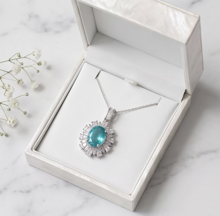 Wonderland 6.2 carat fancy oval cut Paraiba Tourmaline .925 Sterling Silver Handcrafted Statement necklace - Paraiba Tourmaline necklace in box, top view on marble background