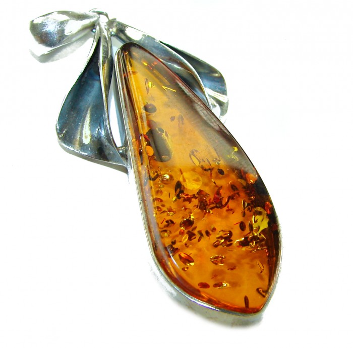Prehistoric Authentic Baltic Amber .925 Sterling Silver beautifully handcrafted Pendant - Close-up of Baltic amber pendant with silver accents against white background