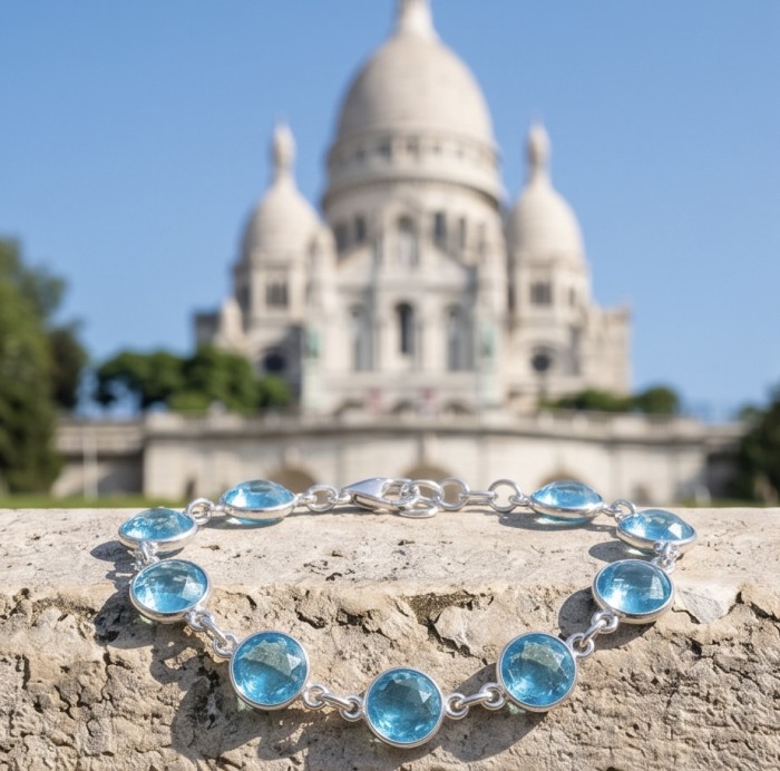 Rare finding - Seaside 18.5 carat authentic Swiss Blue Topaz .925 Sterling Silver handmade Bracelet - Swiss blue topaz bracelet in front of a landmark, top view.