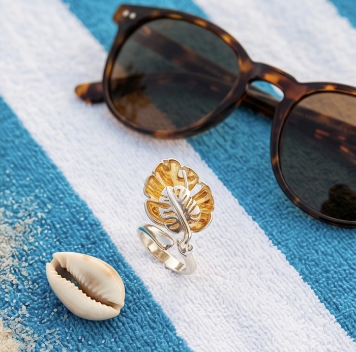 Golden Leaf Authentic carved Baltic Amber .925 Sterling Silver handcrafted ring; s. 7 - Golden leaf ring on towel with sunglasses, shell nearby
