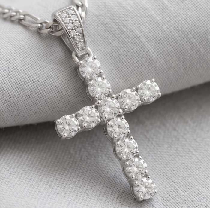Precious Cross Genuine rhodium over .925 Sterling Silver handmade necklace - Cross pendant with diamonds on chain close-up, silver background