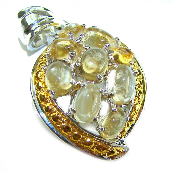 Mystery 12.6 carat Citrine 2 tones .925 Sterling Silver handcrafted pendant - Close-up of citrine and sterling silver pendant with gold accents.