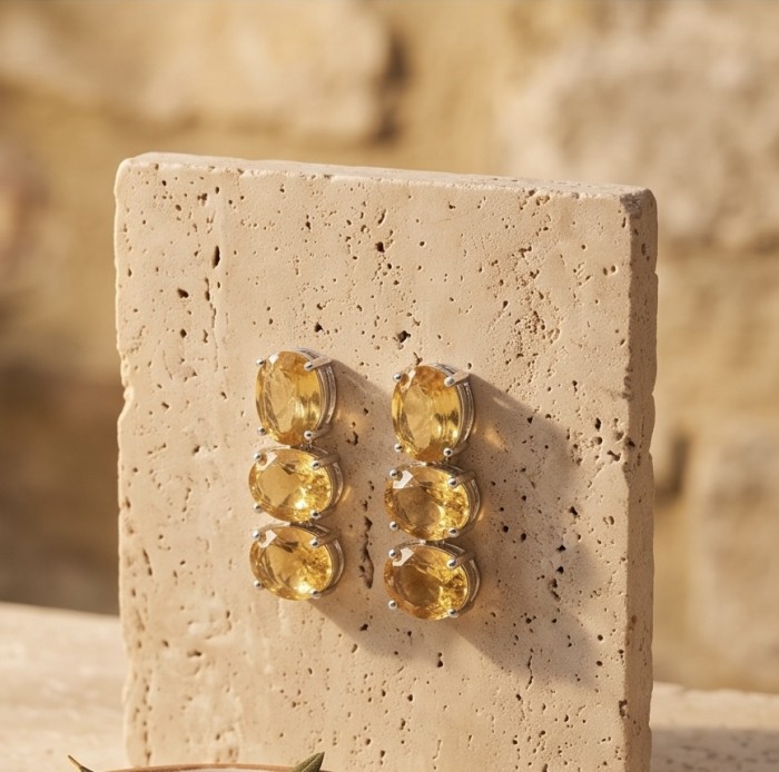 Victoria Authentic 27.2 carat Brazilian Citrine rhodium over .925 Sterling Silver brilliantly handcrafted Statement earrings - Side view of Victoria Authentic Brazilian Citrine earrings on stone block.