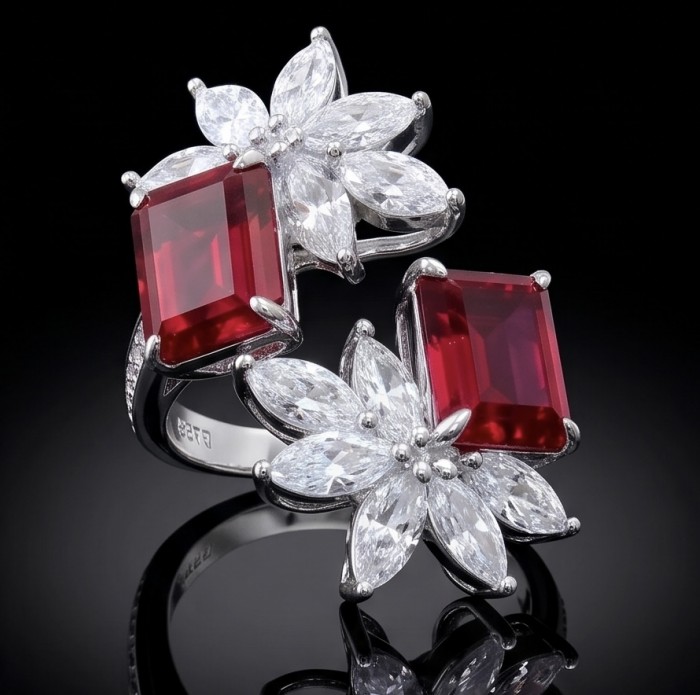 Giovanna - Authentic 8.9 carat Ruby .925 Sterling Silver dipped in rhodium handcrafted Statement Ring size 8 - Close-up of ruby ring with floral diamond accents on black background.