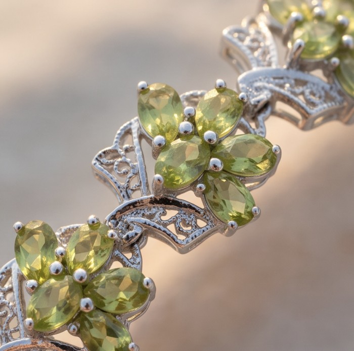 Vittoria Natural 29.8 carat Brazilian Peridot Rhodium over .925 Sterling Silver handmade Statement Bracelet - Close-up of Vittoria Brazilian Peridot stones with intricate silver design.