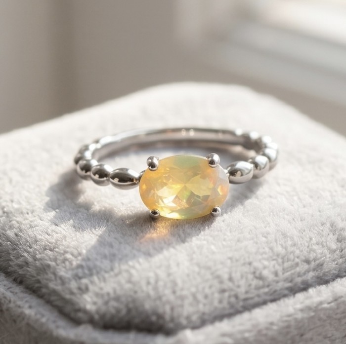A Milky Way Genuine 2.8 carat Fire Opal .925 Sterling Silver handmade Ring size 8 - Fire opal ring close-up on silver band, resting on soft fabric