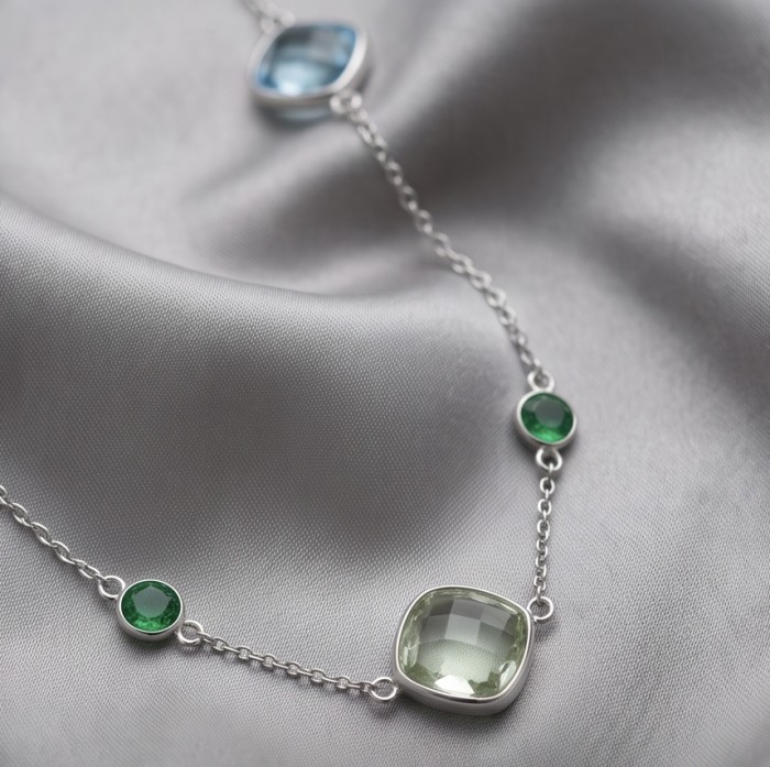 Infinity 18.5 carat Authentic Multigems Rhodium over .925 Sterling Silver handcrafted Statement necklace - Close-up of Infinity multigem necklace on silky fabric backdrop.