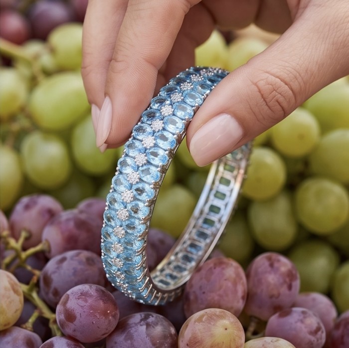 Serenity - Spectacular authentic 152.7 carat Swiss Blue Topaz .925 Sterling Silver handmade bangle Bracelet - Close-up of Serenity bracelet with blue topaz among grapes