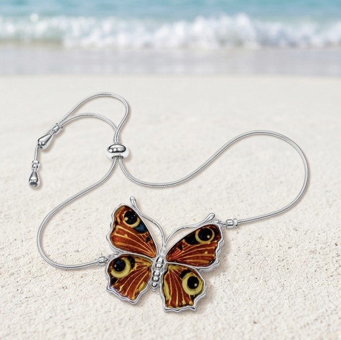 Golden Butterfly Genuine carved Baltic Amber .925 Sterling Silver handamde Bracelet - Butterfly amber necklace on beach background, top view.