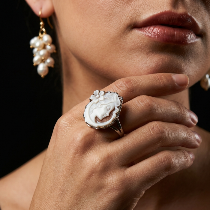 Italy made Exquisite real Cameo from Sea Shell 18K Gold over .925 Sterling Silver handcrafted Statement ring; s. 7 ADJUSTABLE - Close-up of cameo ring on hand, pearl earring visible.