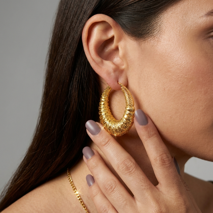 Black Label Collection - Dubai Style - Natural 22K Gold over .925 Sterling Silver handmade hoop earrings - Side view of woman wearing gold hoop earring, hand touching earlobe.