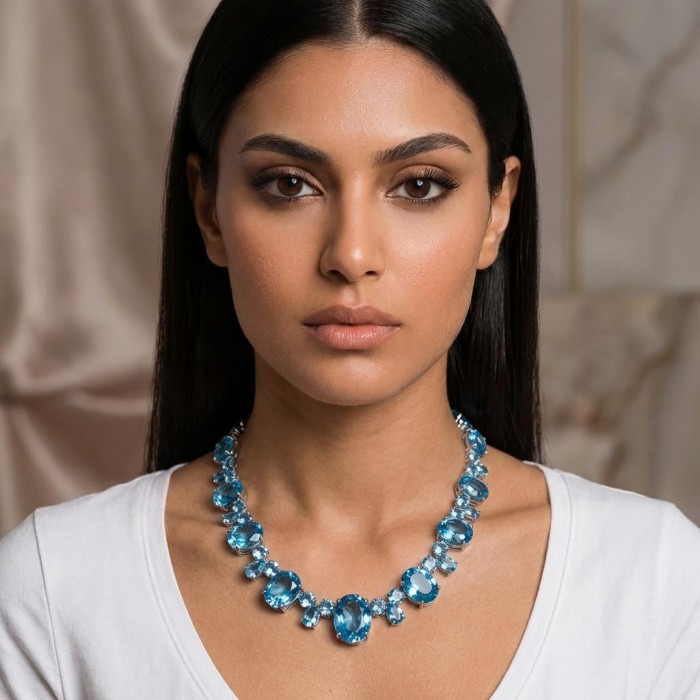 Pure Serenity 225.5 carat genuine Swiss Blue Topaz .925 Sterling Silver handmade Large Statement Necklace; 132.95 grams - Woman wearing Pure Serenity Swiss Blue Topaz necklace, front view.
