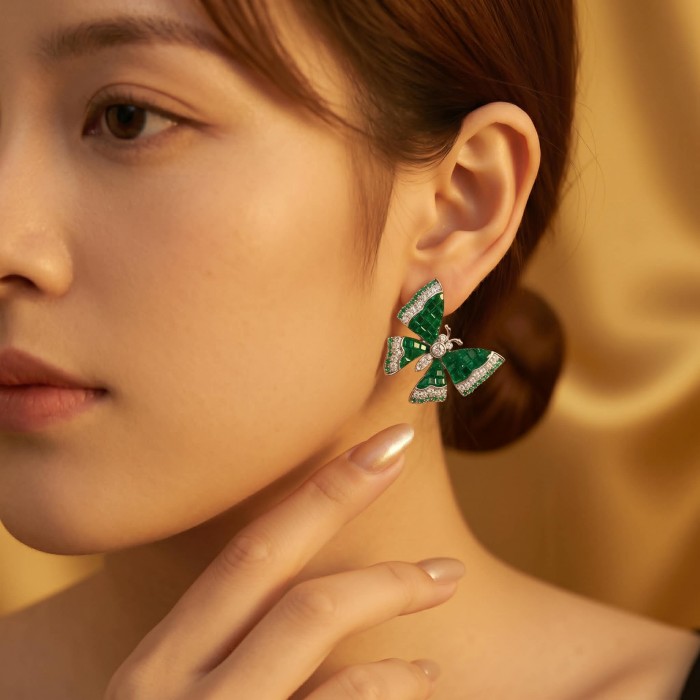 Incredible green Butterflies genuine 11.5 CARAT Emerald .925 Sterling Silver handcrafted Earrings - Side view of emerald butterfly earrings being worn.