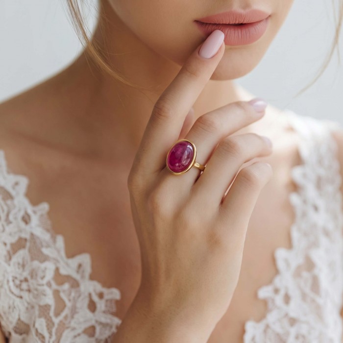 Authentic 10.2 carat Mozambique Ruby 22K Gold over .925 Sterling Silver brilliantly handcrafted ring s. 5 3/4 - Close-up of Mozambique ruby ring on a woman's hand, wearing lace attire.