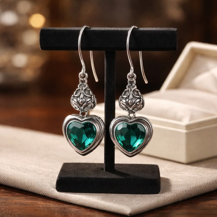 Green Heart Authentic 6.5 CARAT Chrome Diopside .925 Sterling Silver handcrafted earrings - Front view of green heart chrome diopside earrings on stand