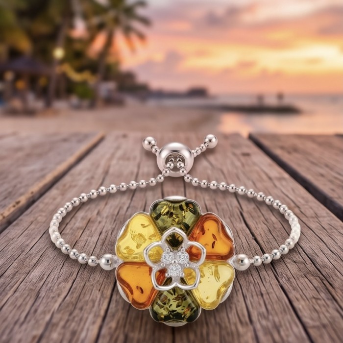Excellent quality Baltic Amber .925 Sterling Silver entirely handcrafted Bracelet - Close-up of Baltic Amber flower bracelet on wooden surface at sunset.