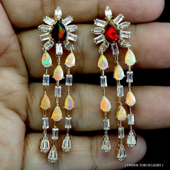 Giovanna 8.2 carat Australian Black Opal Australia Opal 22K Gold over .925 Sterling Silver incredible handcrafted Earrings - Front view of opal and diamond earrings on hand under light.
