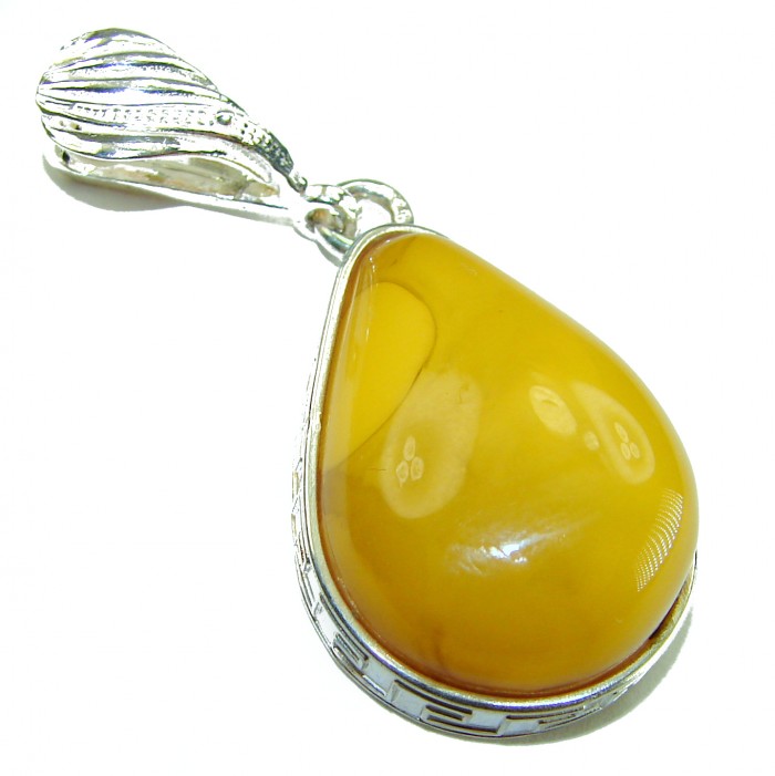 Prehistoric Authentic Buttescotch Baltic Amber .925 Sterling Silver beautifully handcrafted Pendant - Close-up of butterscotch Baltic amber pendant, silver setting detail