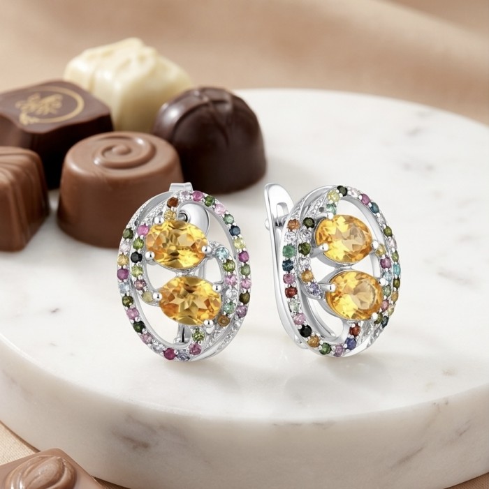 Vivien Luxurious Style - Natural 9.7 carat Citrine .925 Sterling Silver dipped in rhodium handmade earrings - Close-up of citrine earrings on marble with chocolates in the background.