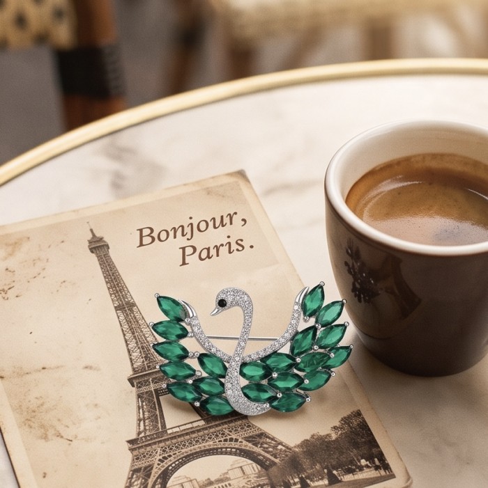 Graceful Swan Genuine 19.5 carat Colombian Emerald .925 Sterling Silver handmade Pendant - Brooch - Graceful Swan brooch with emeralds, on postcard and next to coffee cup.