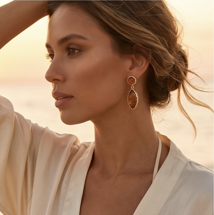 Serenity - Authentic Baltic Amber .925 Sterling Silver handcrafted earrings - Side view of model wearing Serenity Baltic Amber earrings at sunset