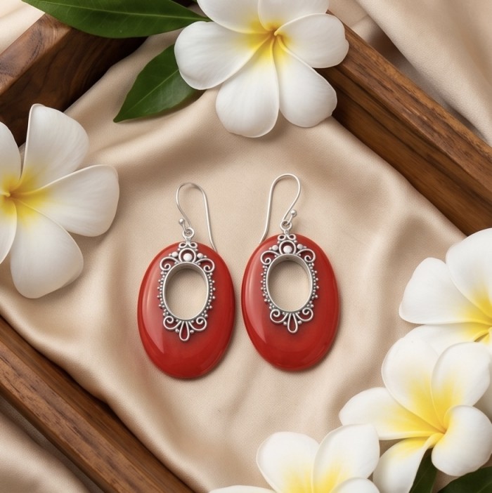LARGE - Genuine Red Fossilized Coral .925 Sterling Silver handmade earrings - Red fossilized coral earrings with floral plumeria backdrop, top view.