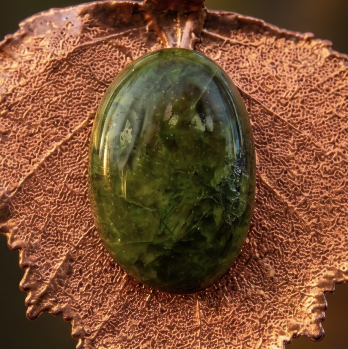 REAL Leaf dipped in copper 30.2 green Tourmaline stone & .925 Sterling Silver Pendant - Green Tourmaline on copper-dipped leaf, close-up view.