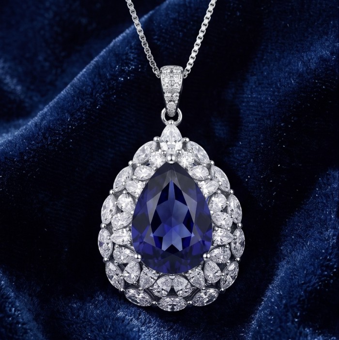Handcrafted - authentic 15.8 carat African Kyanite .925 Sterling Silver dippedin rhodium handmade necklace - Teardrop necklace, close-up of kyanite and diamond gemstones on velvet.